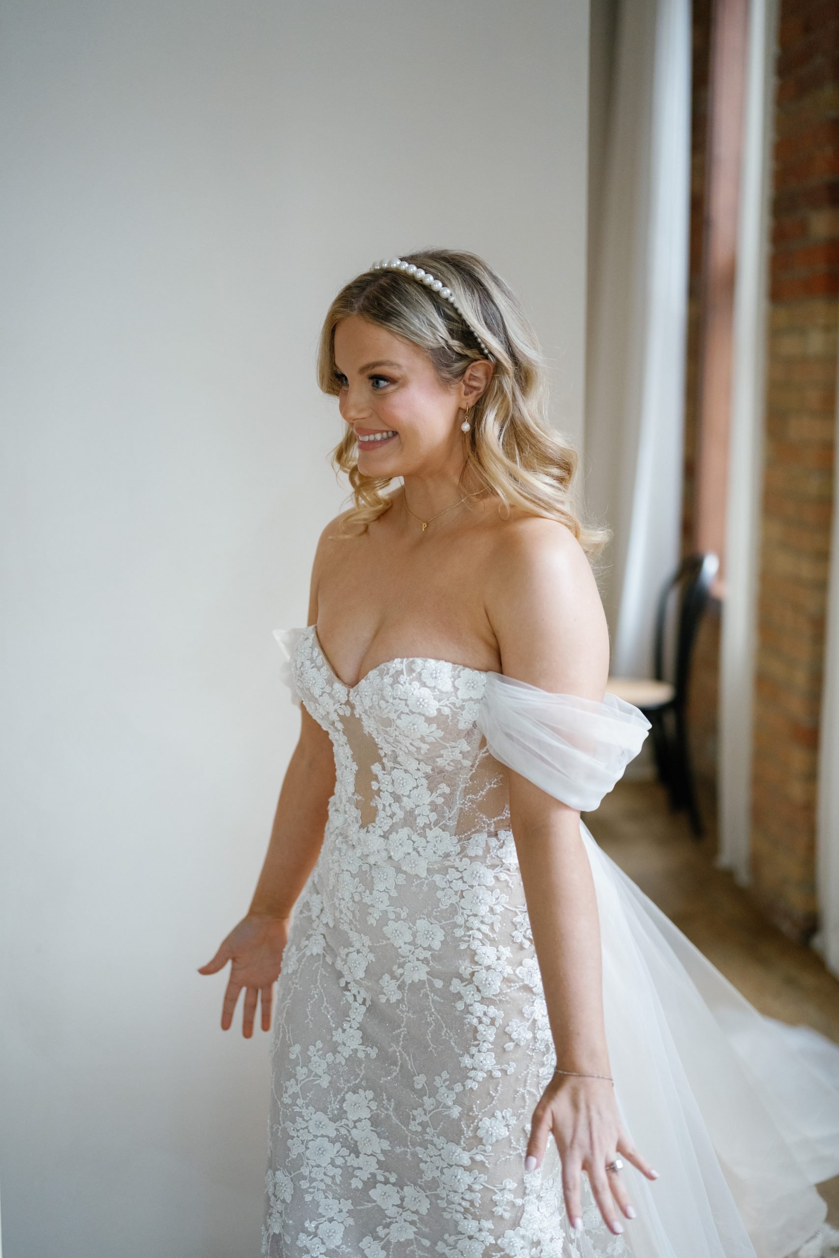 bride walks through the door to meet her brother and father for a first look, at Archive Studios