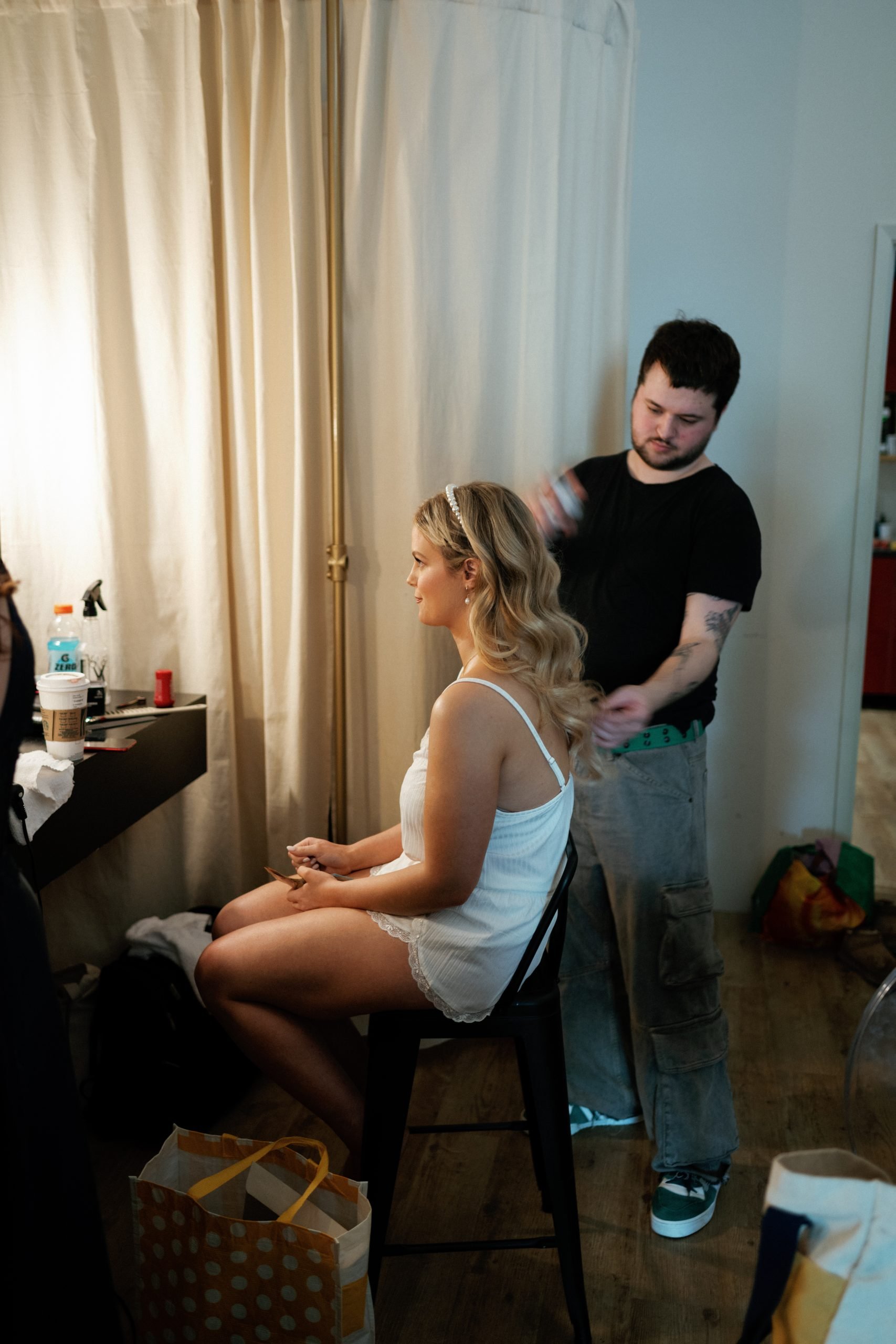 Bride having her hair done with classic waves, at Archive Studios in Toronto