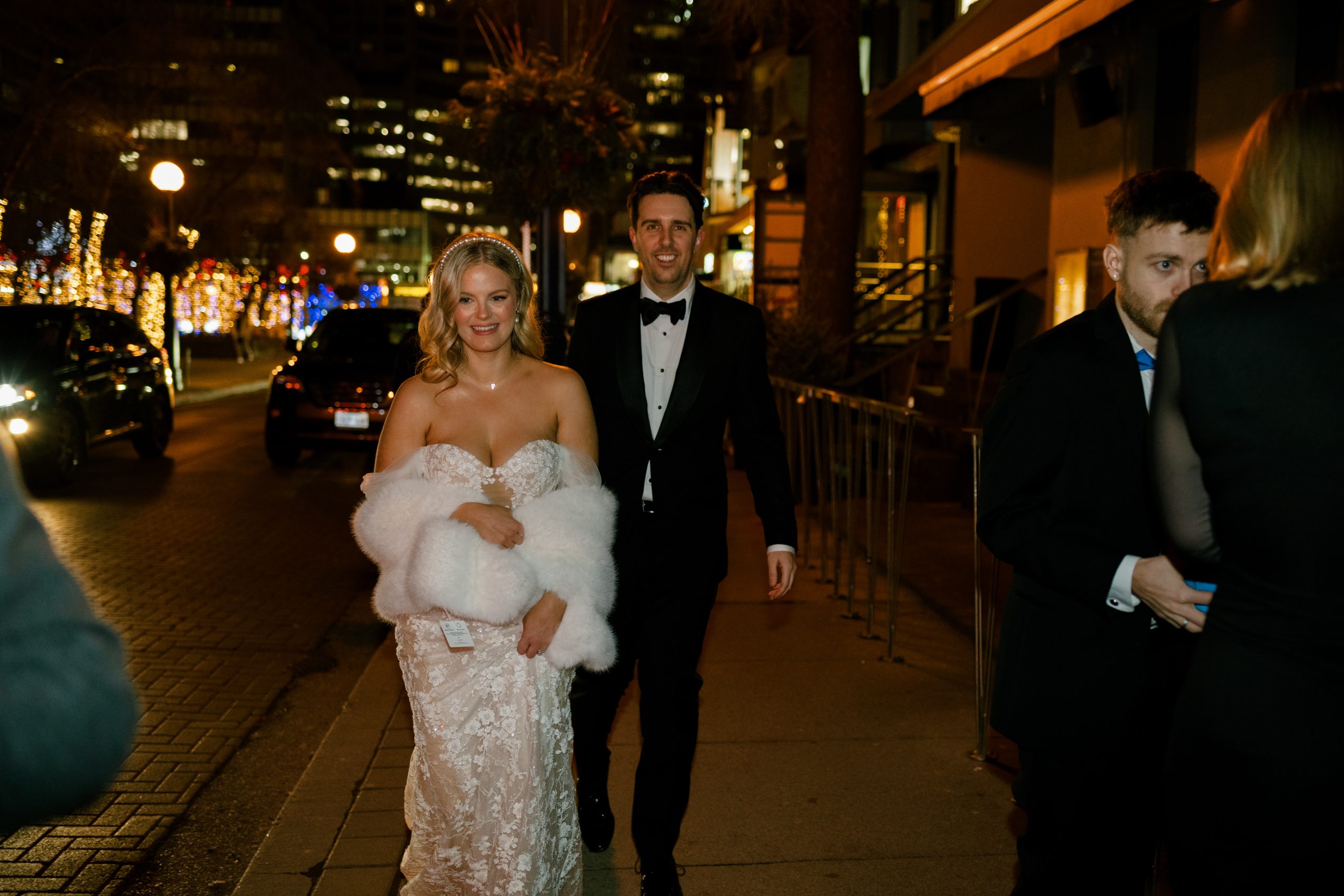 couple walks around Yorkville at night on wedding night