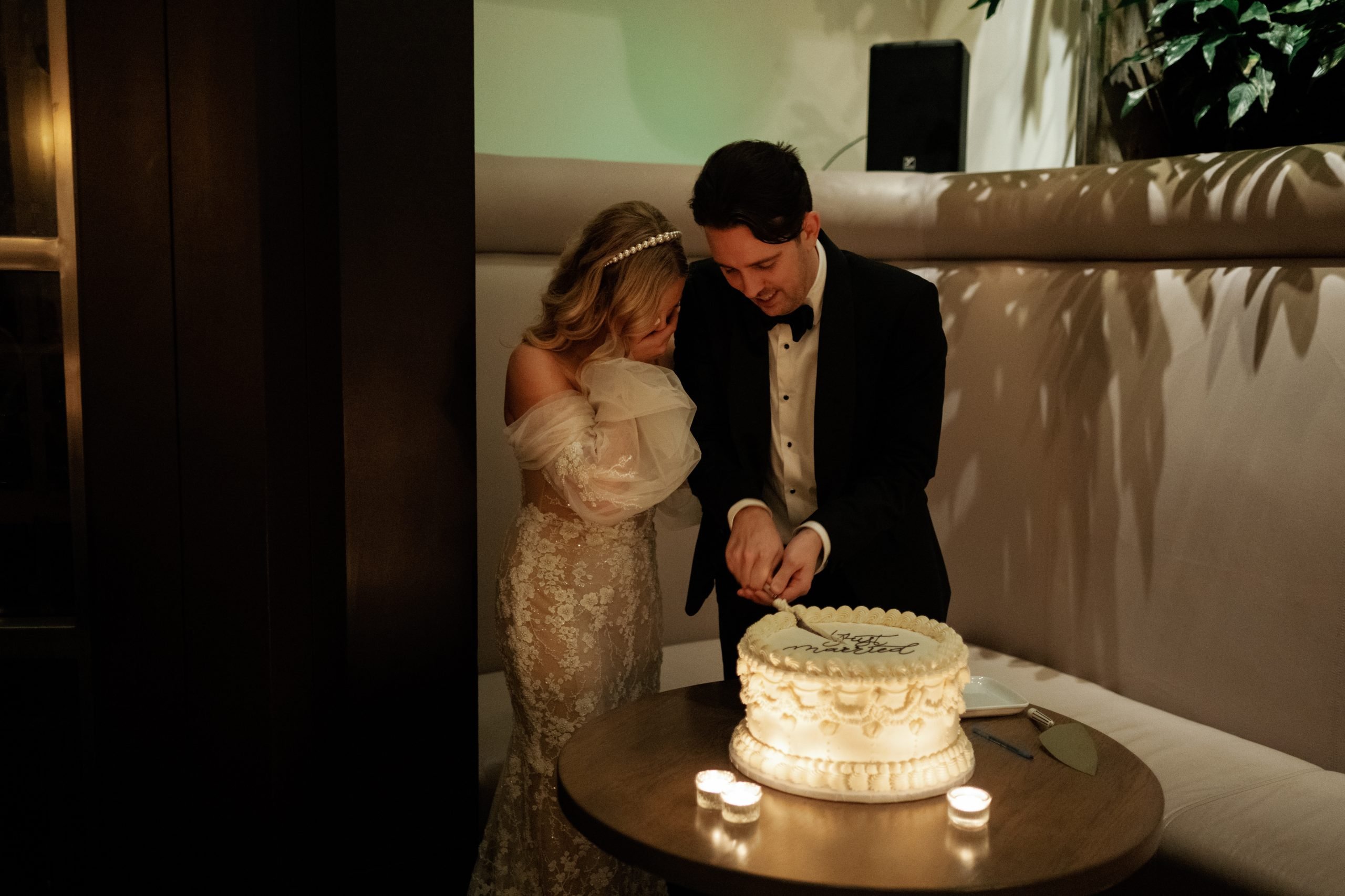 Couple cuts the cake, shot on Portra 400 film