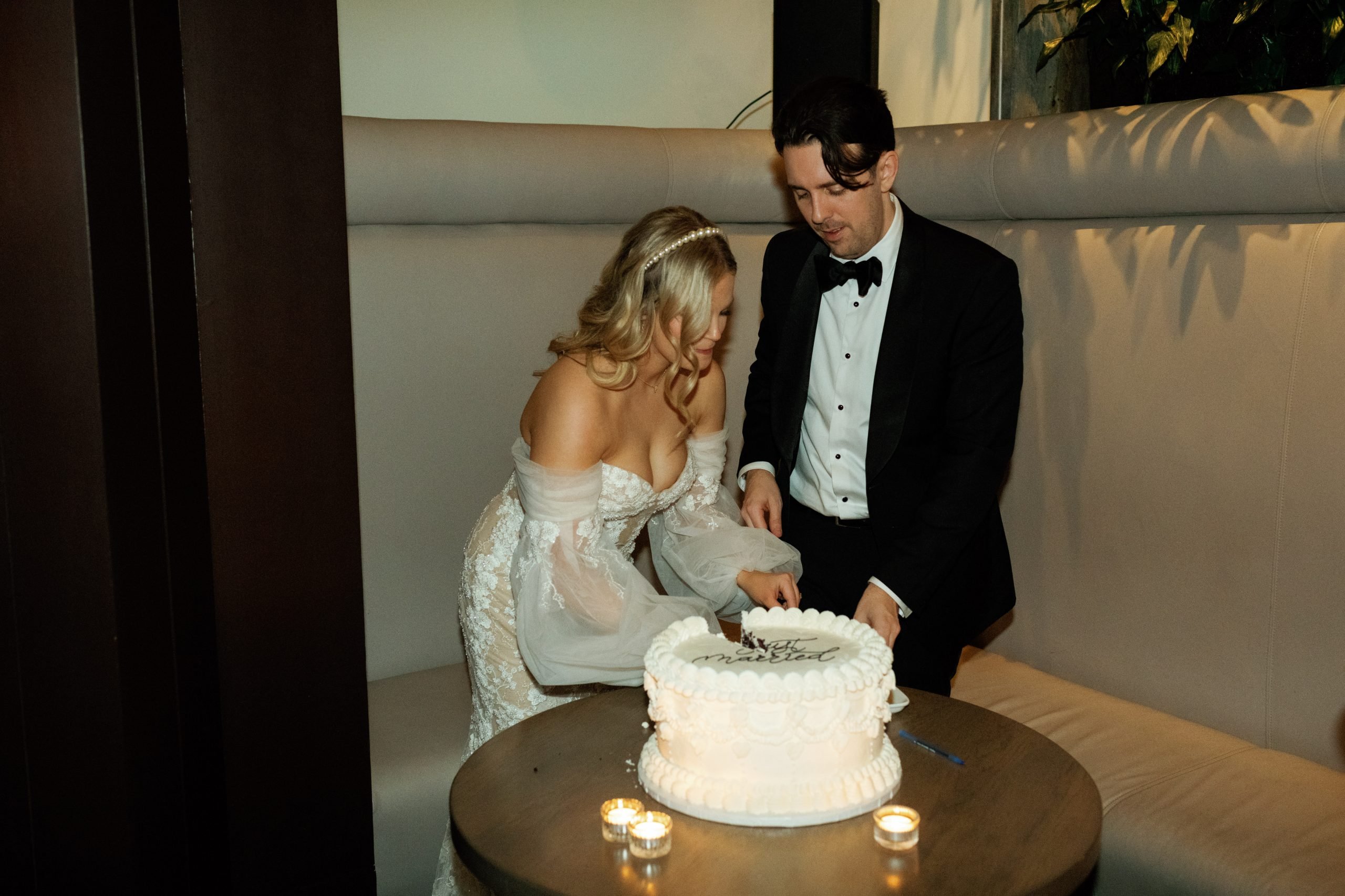 Couple cuts the cake, shot on Portra 400 film
